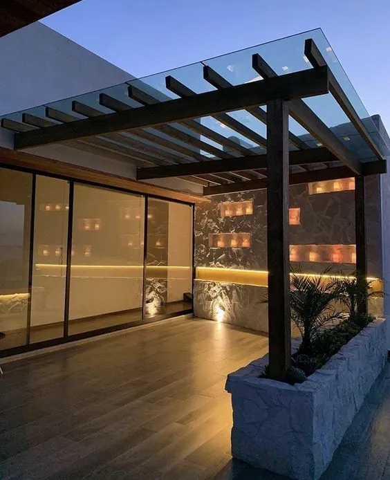Wooden pergola with glass roof on a rooftop terrace at dusk — BlueCrest, Egypt